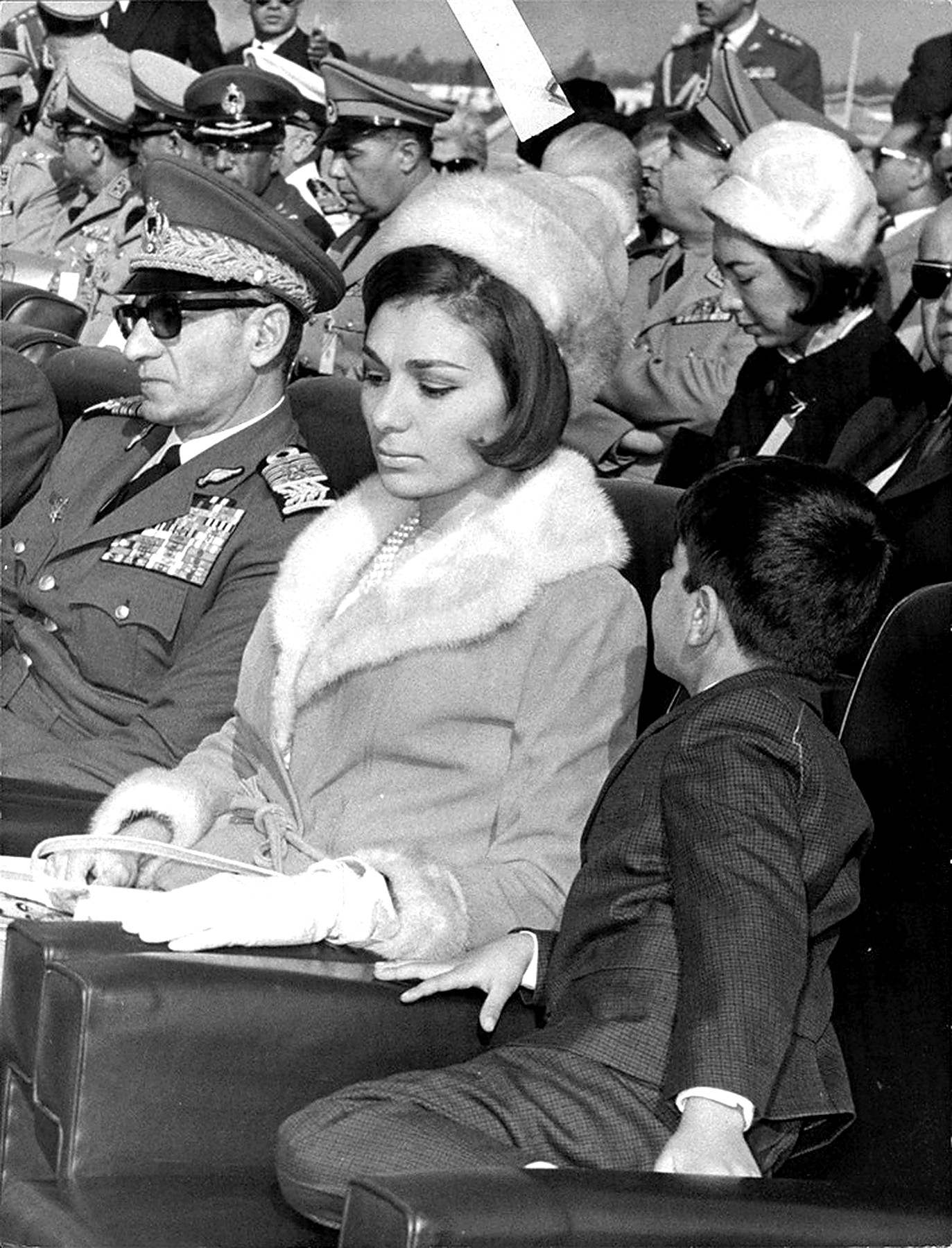 Farah Pahlavi And Mohammad Reza Shah Pahlavi In Their Seats.