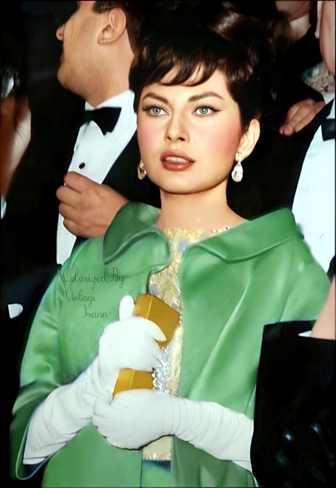 Farah Pahlavi in emerald satin cape.