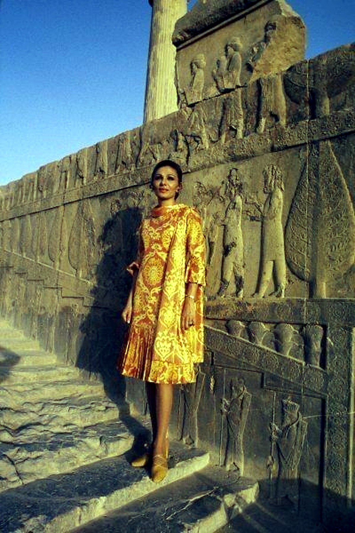 Farah Pahlavi at Persepolis in gold.
