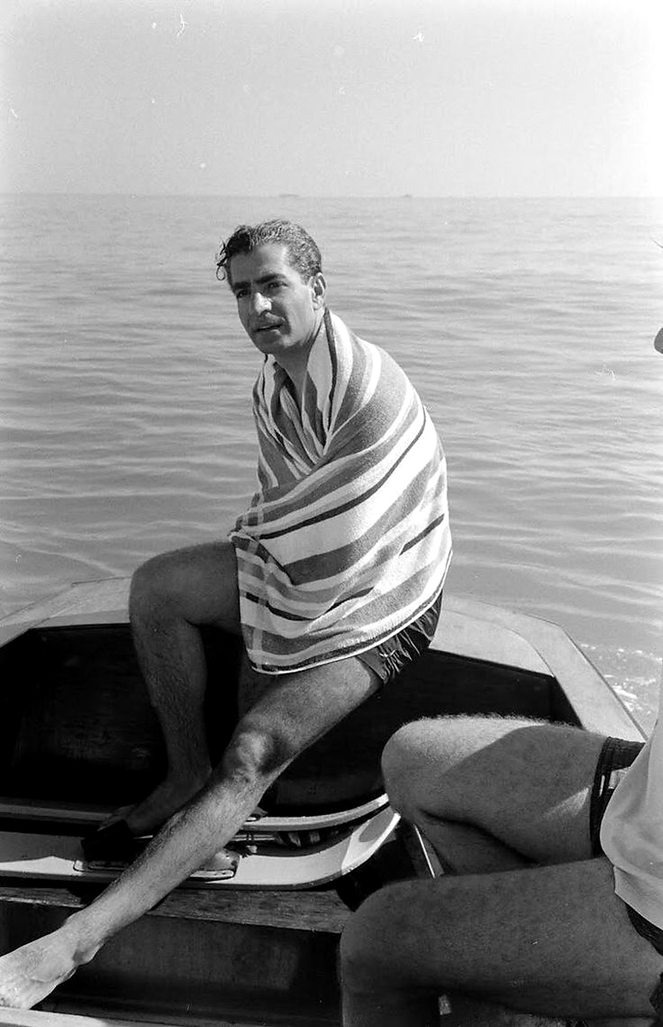 On a boat with a striped towel.