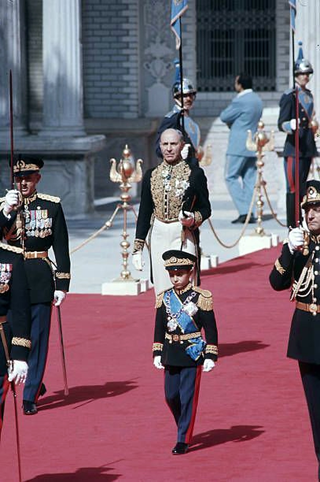 The Shah and young Crown Prince on the red carpet.