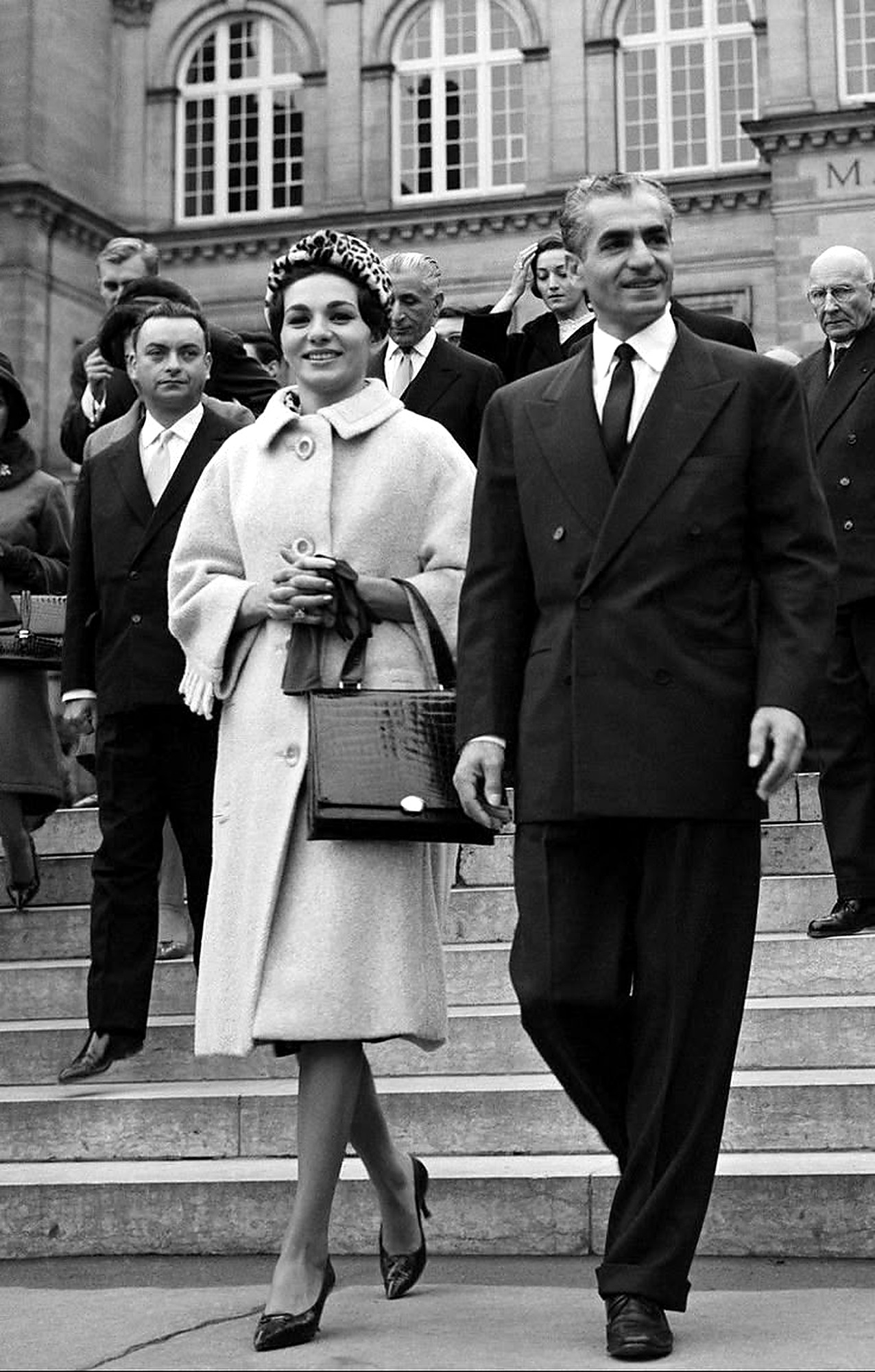 Farah and the Shah walking in the city.